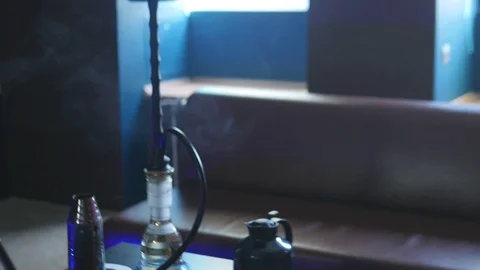 A Man is Sitting in a Cafe in Front of a Hookah Stock Footage 75259240