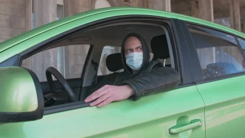 A man sitting in a car and taking a photo with a professional camera, a private 스톡 동영상 153143157