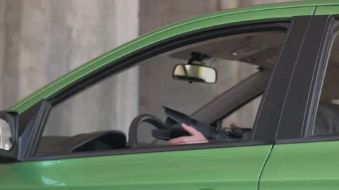 A man sitting in a car and taking a photo with a professional camera, a private Stock Footage 153671095