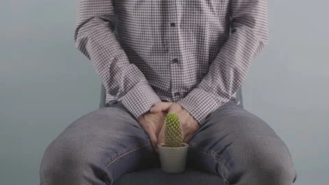 Man sitting on chair Prostate problems conception studio shot mens health Stock Footage 231316336