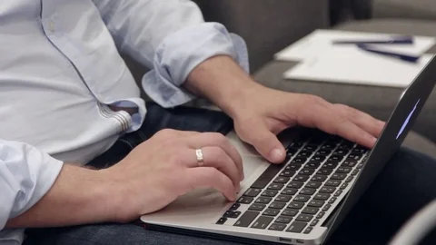 Man sitting on chair working in laptop Stock Footage
