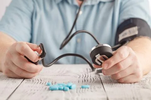 Man Sitting Checking His Own Blood Pressure Foto stock