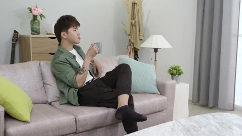 Man sitting comfortably on the sofa Video stock 152745659