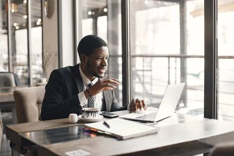 Man sitting at the computer and drinking coffee Fotos Stock