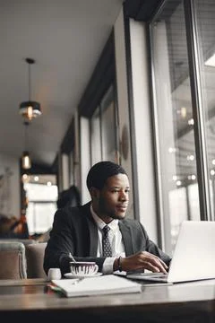Man sitting at the computer and drinking coffee Stock Photos