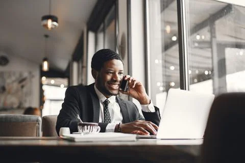 Man sitting at the computer and drinking coffee Fotos Stock