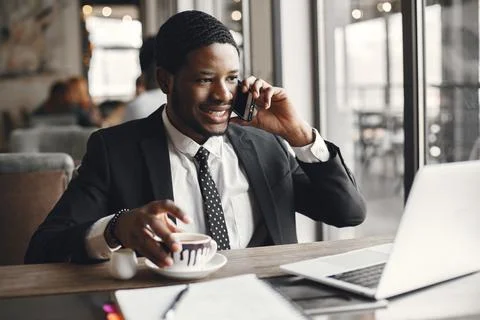 Man sitting at the computer and drinking coffee Stock Photos