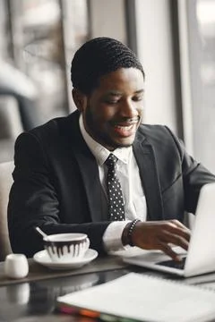 Man sitting at the computer and drinking coffee Stock Photos