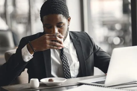 Man sitting at the computer and drinking coffee Stock Photos