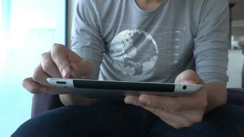 A man is sitting on a couch and using a tablet Stock Footage 318863306