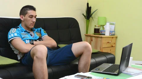 Man sitting on a couch and watching television&amp;computer Stock-Footage 38830565