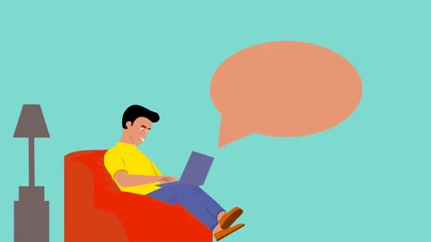 Man is sitting on the couch playing laptop casually Or Man Work at Home Stock Footage 244937579
