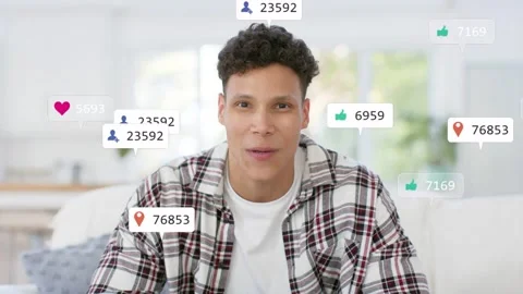 Man sitting on couch talking, causing social icons popping around head, showing Stock Footage 333413991