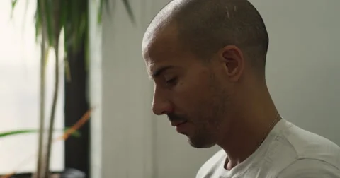 Man sitting on couch using laptop in living room Stock Footage 63374140