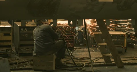 Man sitting on a crate and grinding in factory 1 Stock Footage 129850616