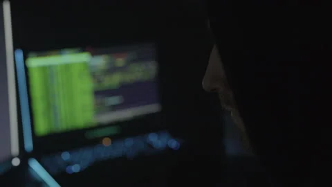 Man Sitting in the Dark with Blurry Code Stock Footage 208746698