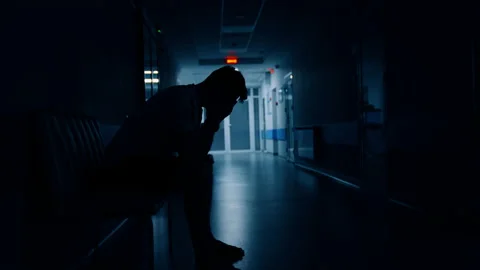 Man sitting in the dark corridor of the maternity hospital.  Stock Footage 239123403