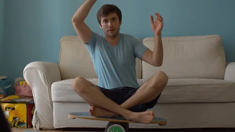 Man sitting on deck for balance Stock Footage 127649670