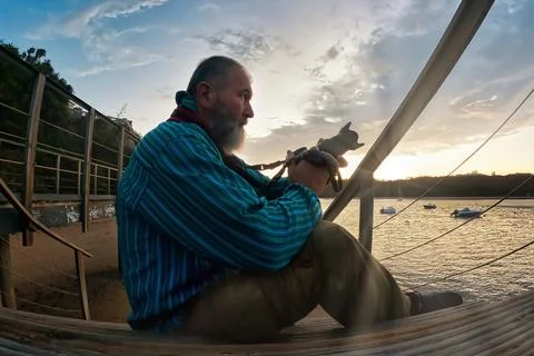 A man sitting on the deck Stock Photos