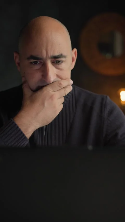 Man sitting at a desk and touching his chin in deep thought to solve a problem Stock Footage 344144266