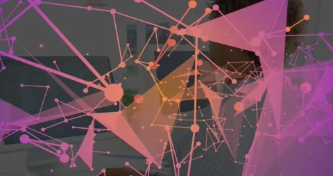 Man sitting desk computer starting pink triangular network mapping data Stock Footage 331198170
