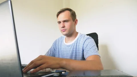 A man sitting at a desk at home, working at home laptop. 스톡 동영상 106689503