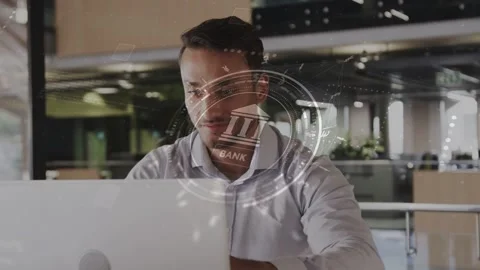Man sitting at desk in open office, bank HUD appearing, guiding typing and Stock Footage 333873370