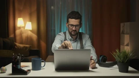 Man sitting at desk, she opens her laptop and starts her work Stock Footage 157492141