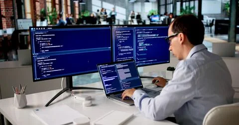 Man Sitting At Desk Typing Code To Develop New Web Project Confidently. 스톡 사진