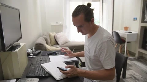Man sitting at the desk while working at home. Stock Footage 134943146