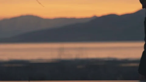 Man Sitting Down by a Lake Stock Footage 73900140