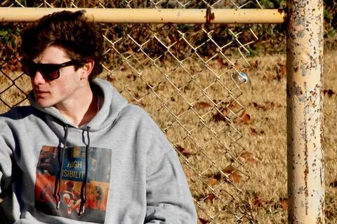 Man Sitting Down Outside in Park Looking to His Right Stock Photos