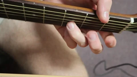Man sitting down playing his guitar in open tuning Stock Footage 279909206