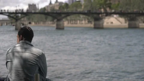 Man sitting by edge of river Stock Footage 125811186