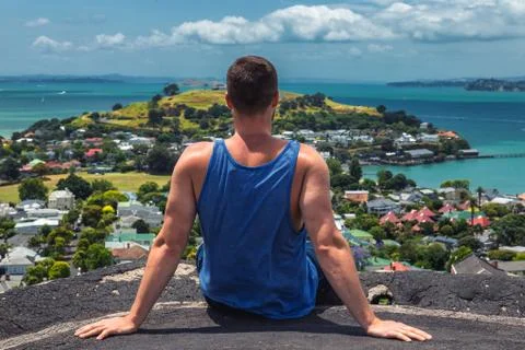 Man sitting on the edge of view point in Auckland, New Zealand Stock Photos