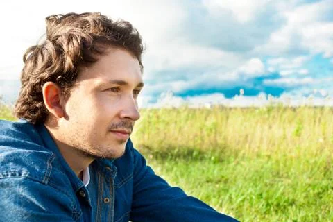 Man sitting in a field Stock Photos