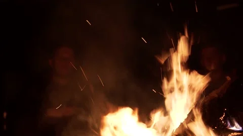A man sitting by the fire in the midsummer evening Stock Footage 133940461