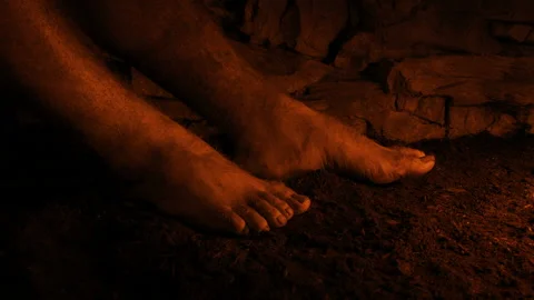 Man Sitting In Firelight In Medieval Setting Stock Footage 221171369