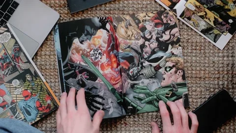 Man sitting on a floor and reads comic book in living room at home. Stock Footage 152936031