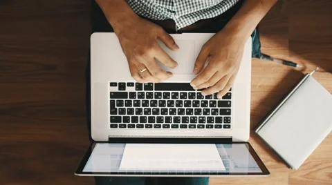Man sitting on the floor and working on a laptop, top view Vídeo Stock 54327424