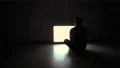 The man sitting on the floor in front of the television with white screen 4k or 4k+ Resolution