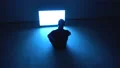 The man sitting on the floor near the television 4k or 4k+ Resolution