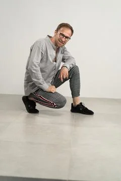 Man sitting on floor Photos
