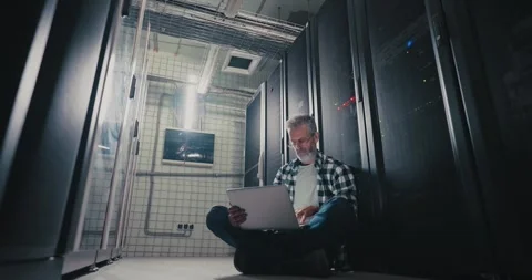 Man Sitting on Floor in Server Room Stock Footage 275904006