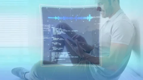 Man sitting on floor by window with blinds, holding tablet and manipulating Stock Footage 334040709