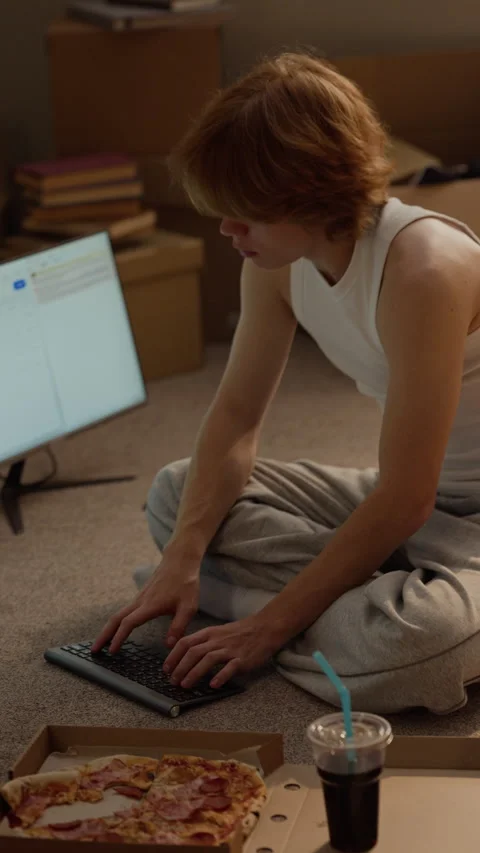 Man Sitting on Floor Working on Computer with Wireless Keyboard Stock Footage 346602935