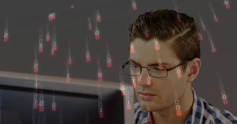 Man sitting focusing on screen, starting cascading binary symbols over glasses Stock Footage 329899660