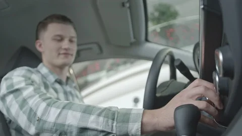 Man sitting on front seat in car with good designed salon. Stock Footage 101104763