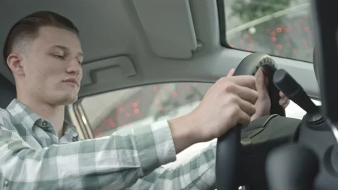 Man sitting on front seat in car with good designed salon. Video stock 101109640