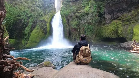 Man Sitting in front of Waterfall Stock Footage 294119769
